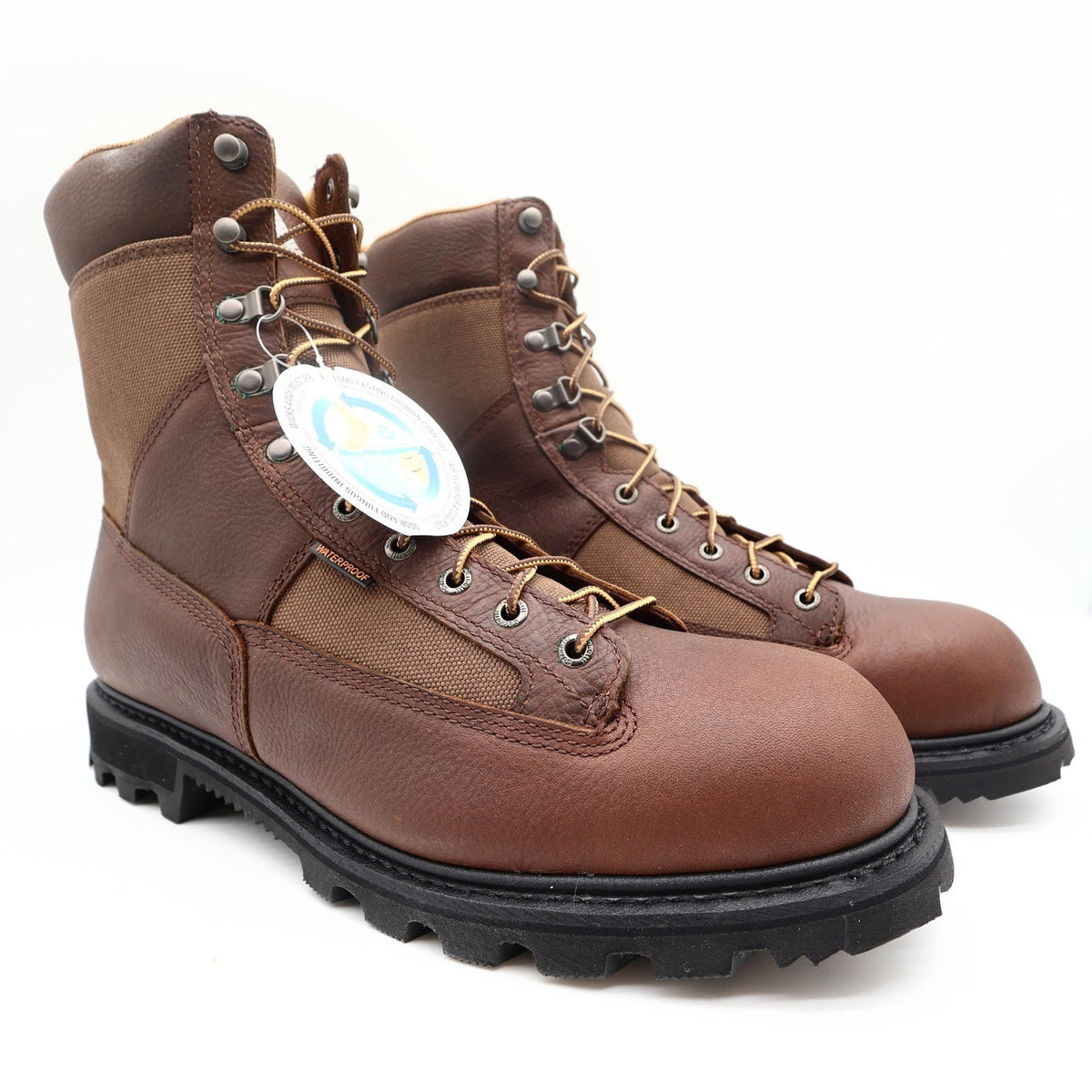 Pair of Carhartt brown leather logger boots with lug soles and hangtag, front angle