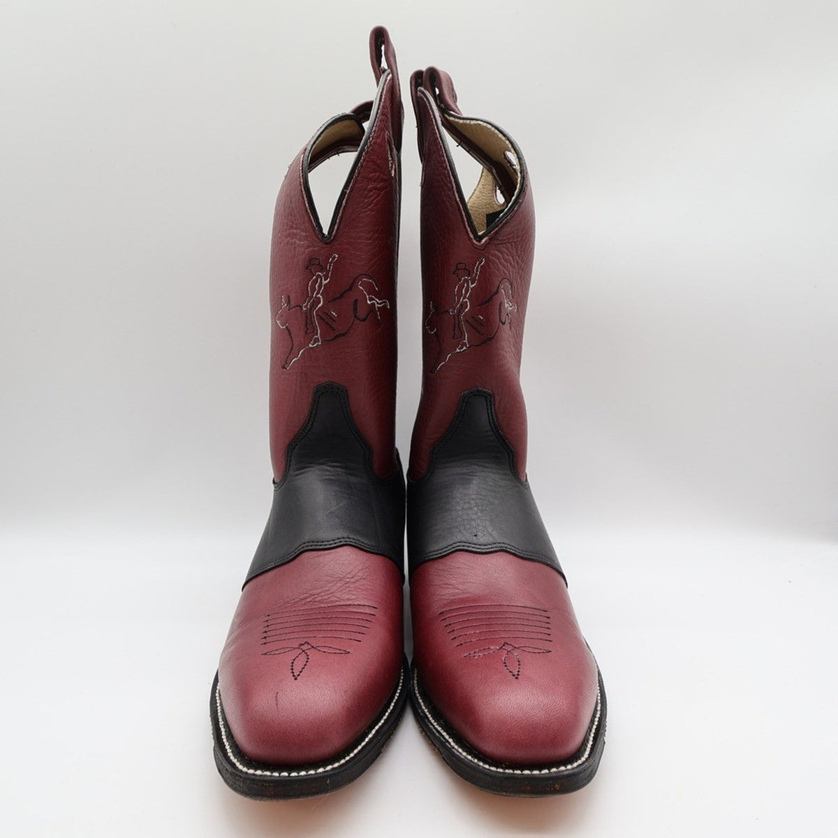 Front view of Double-H burgundy cowboy boots showing toe stitching and bronc rider design