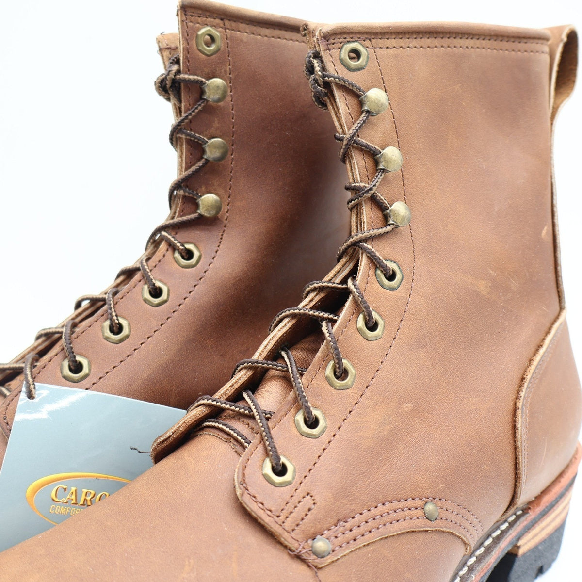Close-up of brass eyelets, speed hooks, and brown laces on Carolina logger boots