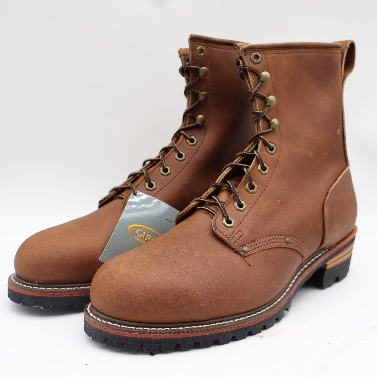 Carolina brown leather logger boots with hangtag, showing stacked heel and lug sole
