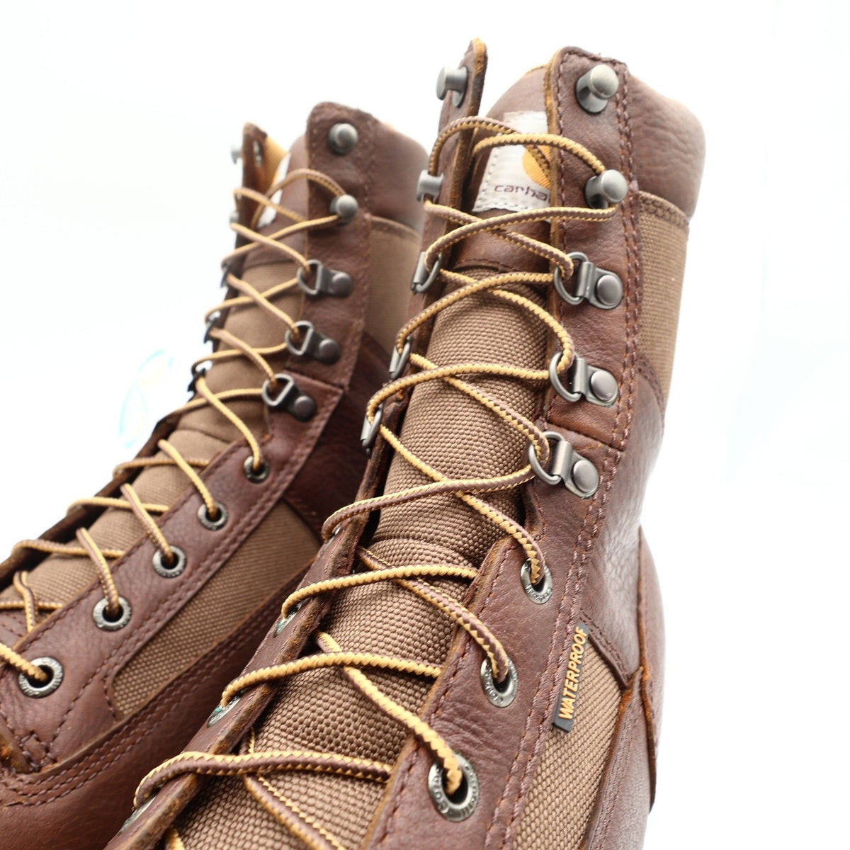 Close-up of Carhartt boot laces, speed hooks, tongue logo, and waterproof tag
