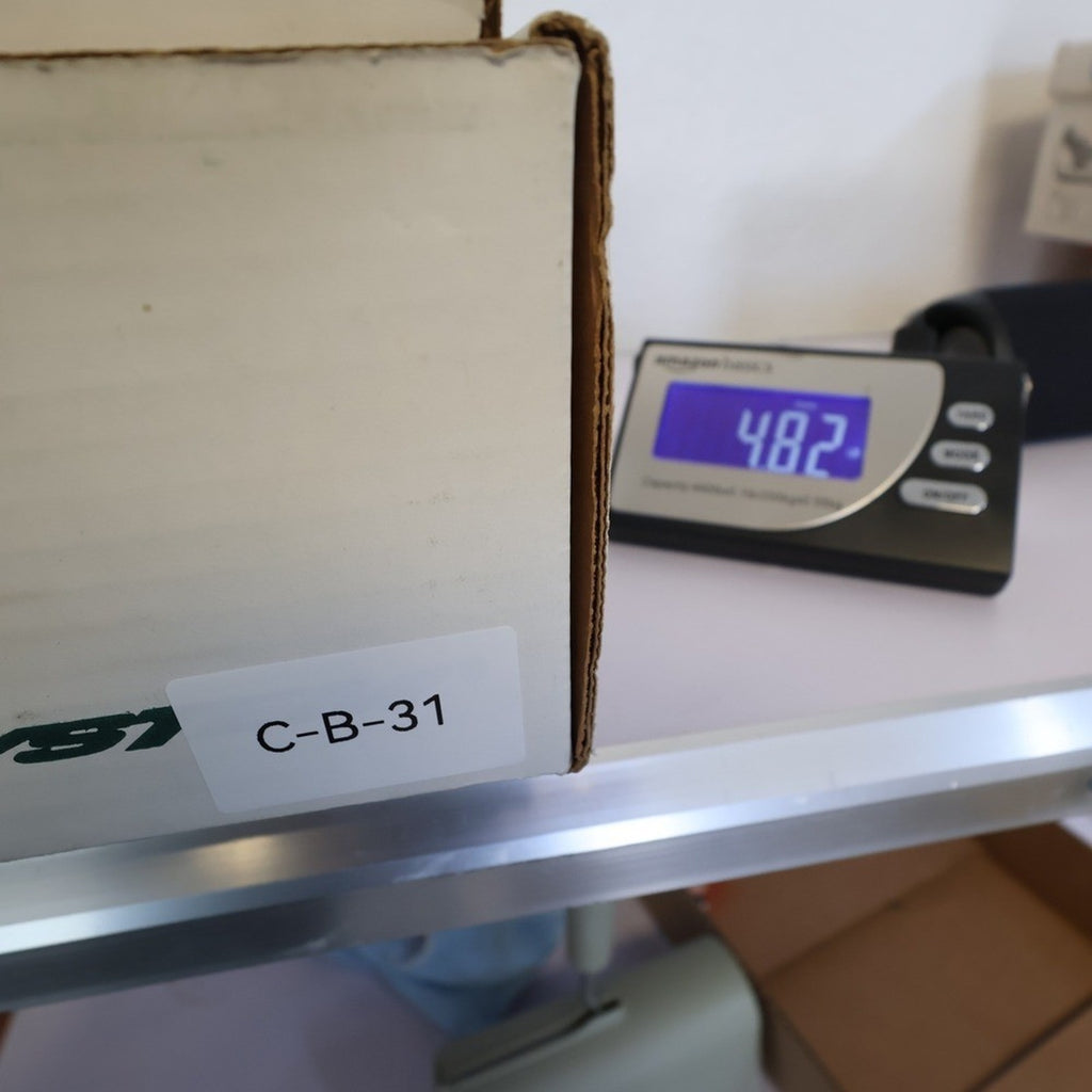 Double-H boot box next to a shipping scale reading 4.82
