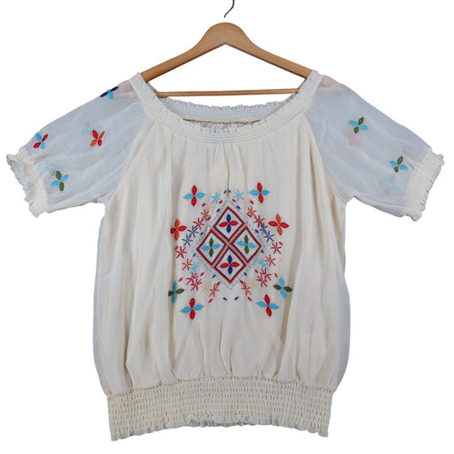 Ivory Angie blouse with colorful embroidery, front view on hanger