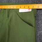 Ruler across the waistband of green Aldens pants