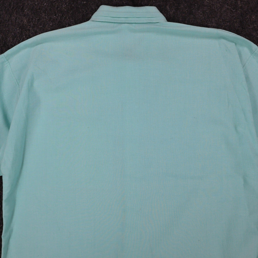 Close-up of the back collar and shoulders of an aqua blue Alexxus short-sleeve shirt