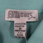 Close-up of the Alexxus brand, size and fabric-content labels inside an aqua blue shirt