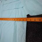 Ruler across the chest of aqua blue Alexxus short-sleeve shirt