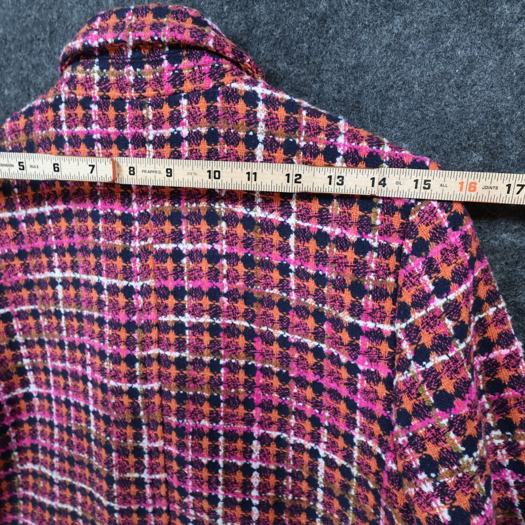Pink, orange and navy AURA plaid double-breasted coat, measuring tape across the shoulders