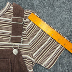 Ruler along the sleeve of the striped Amy Too top beneath a brown jumper dress