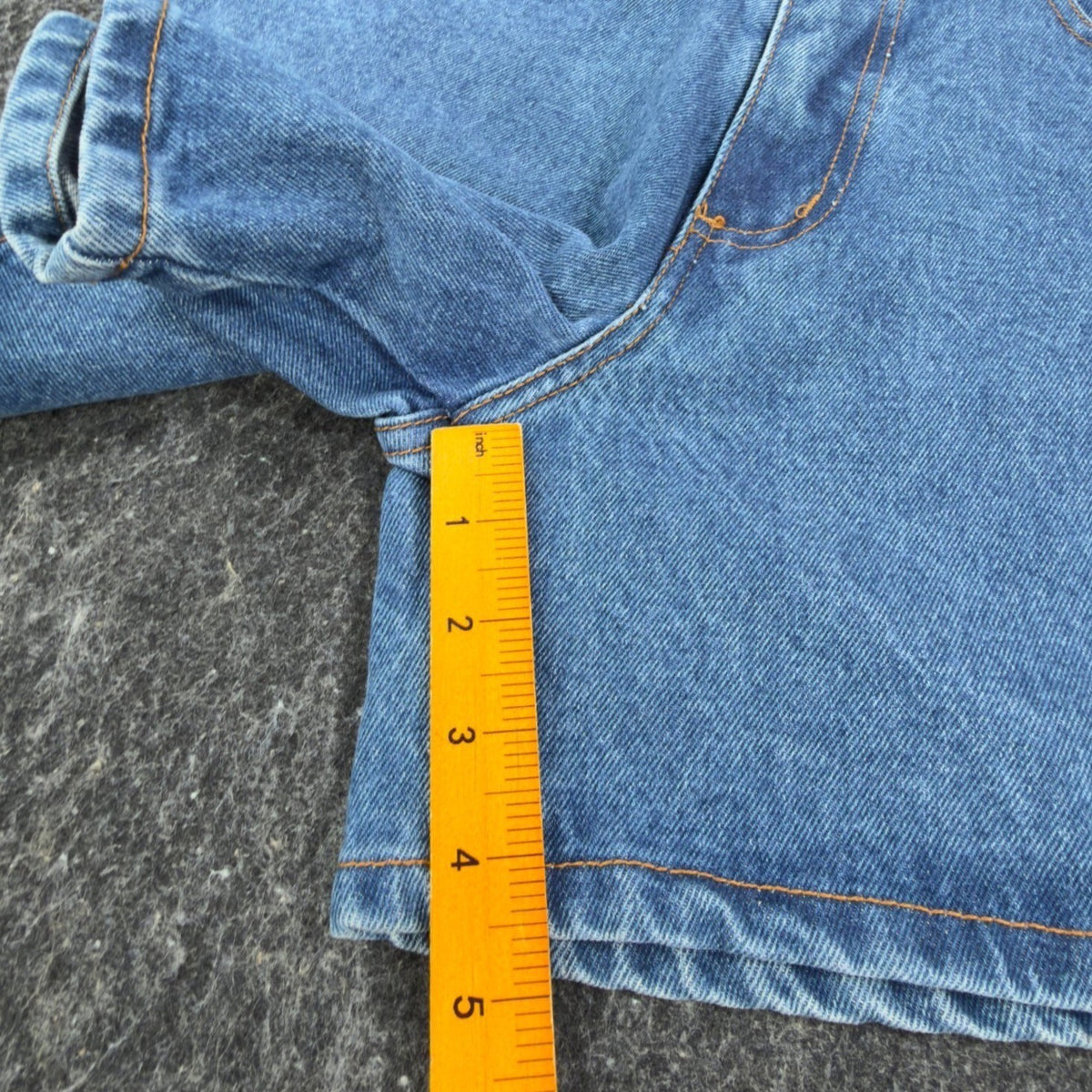 Ruler positioned along the inseam of blue Boom Boom denim shorts