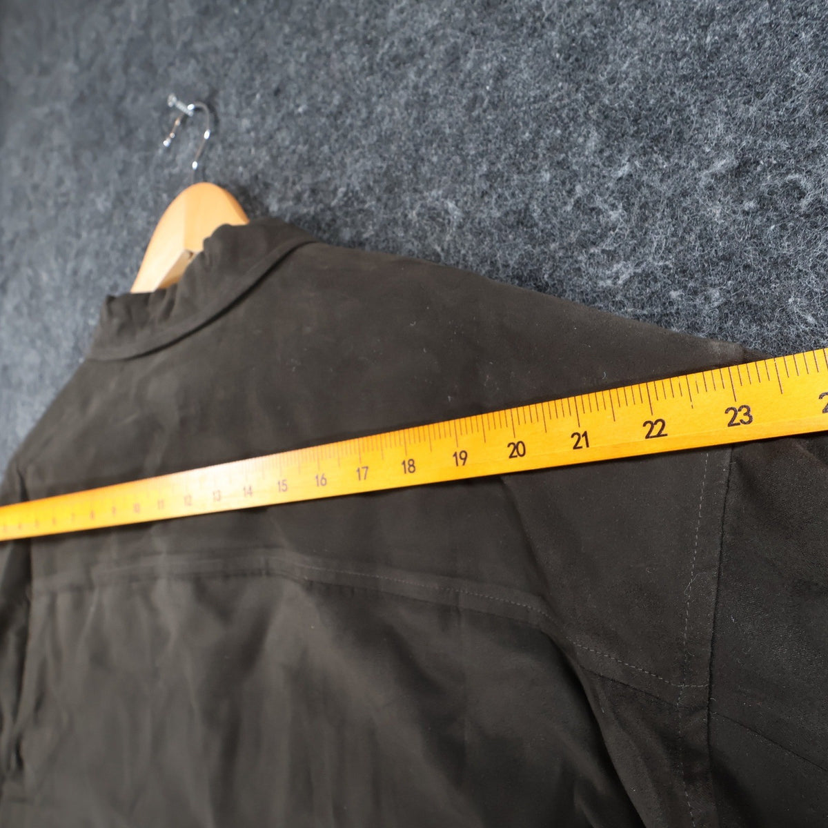 Ruler across the shoulders of brown Alan Flusser button-front shirt jacket
