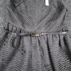 Close-up of the textured bodice, gathered waist and black belt