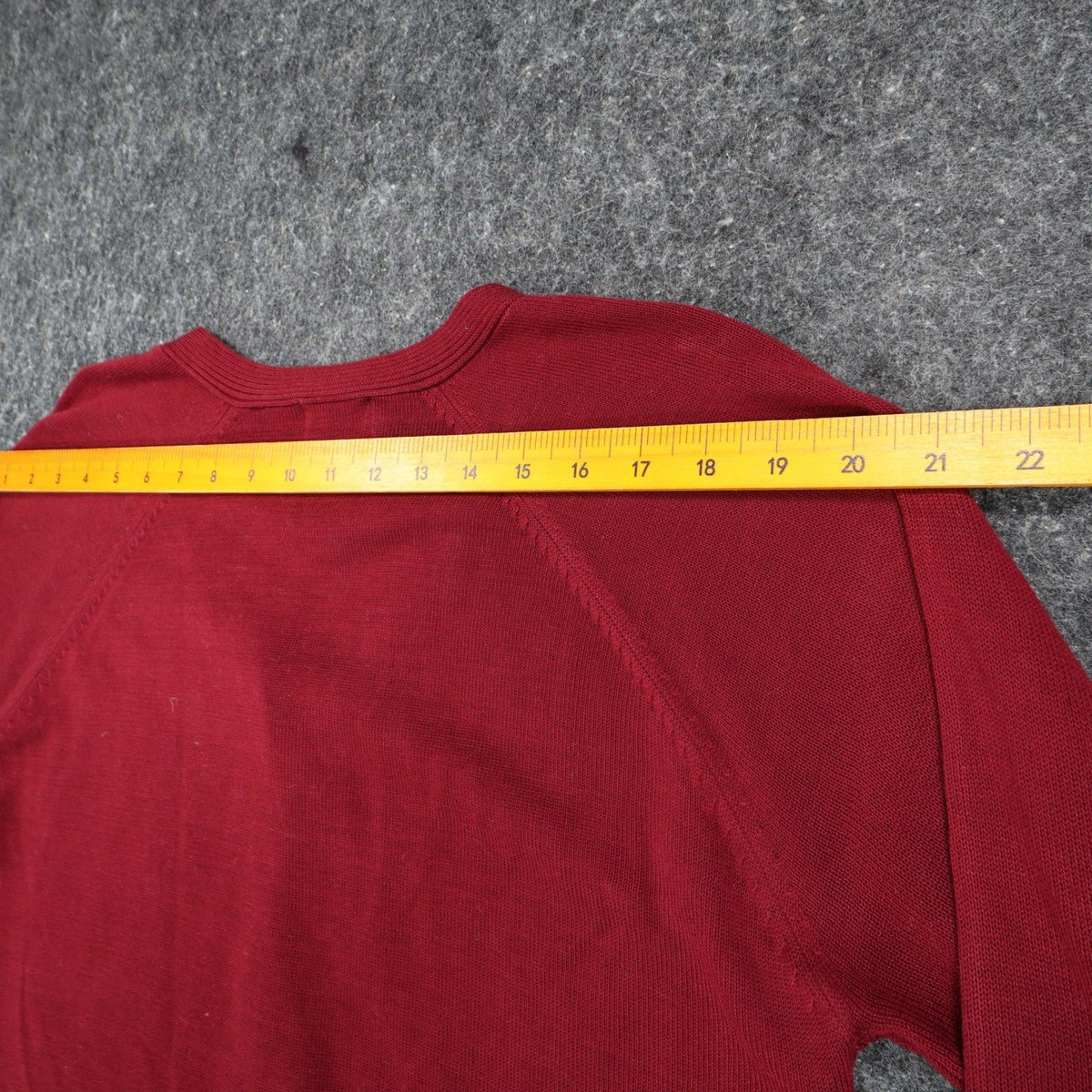 Wine-red Southern Lady button-front cardigan, ruler across upper back