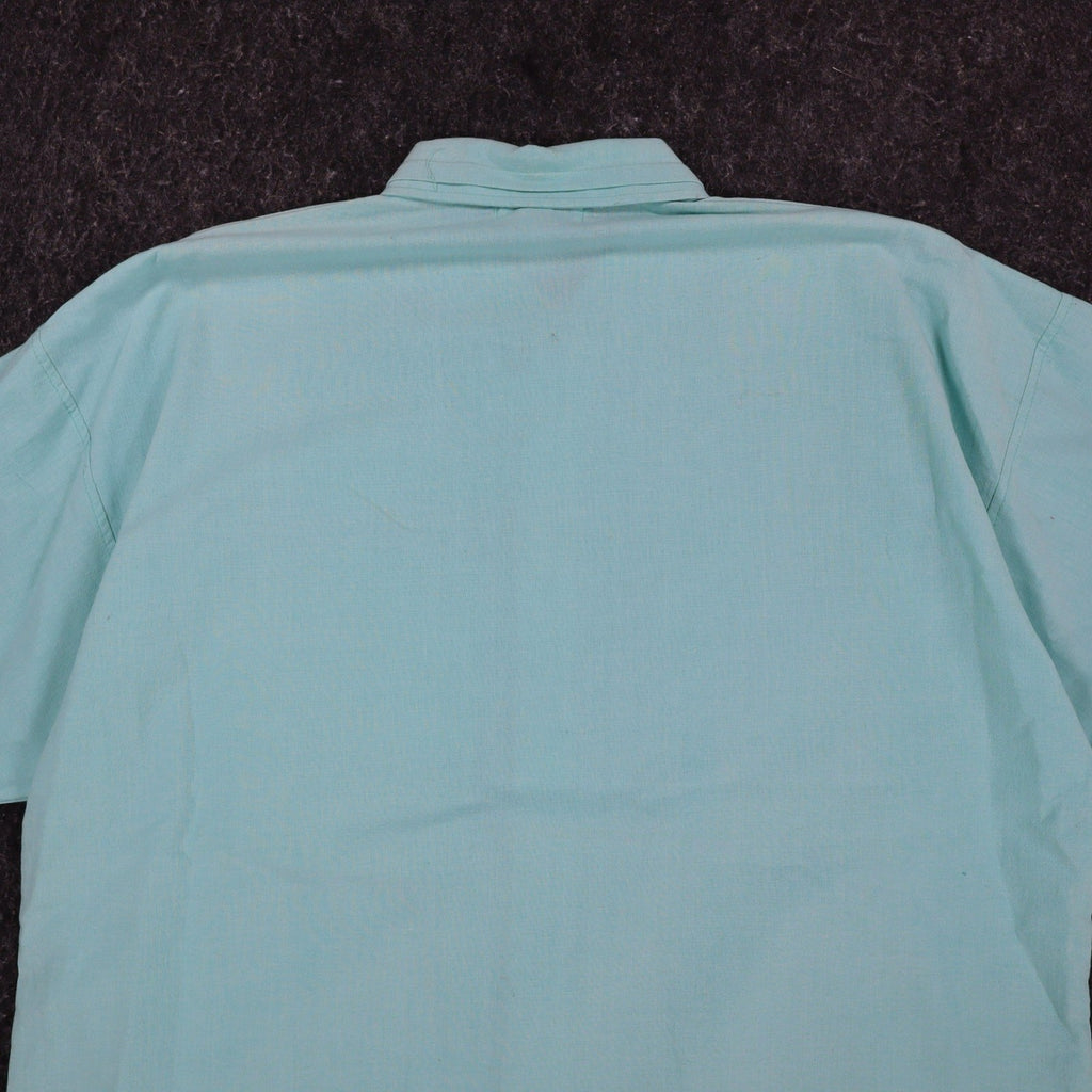 Close-up of the back collar and shoulders of an aqua blue Alexxus short-sleeve shirt