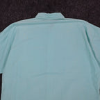 Close-up of the back collar and shoulders of an aqua blue Alexxus short-sleeve shirt