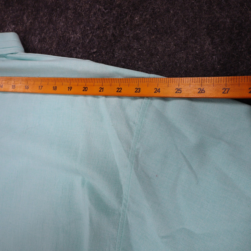 Ruler across the shoulders of aqua blue Alexxus short-sleeve shirt