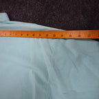 Ruler across the shoulders of aqua blue Alexxus short-sleeve shirt