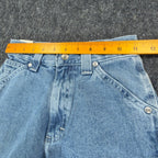 Ruler across the waistband of light blue Lee wide-leg carpenter jeans