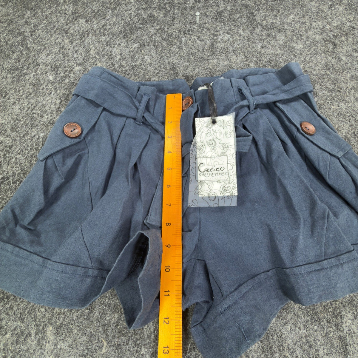 Blue Cecico belted pleated shorts, front rise ruler view