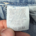 Close-up of a faded care, fabric-content and size label
