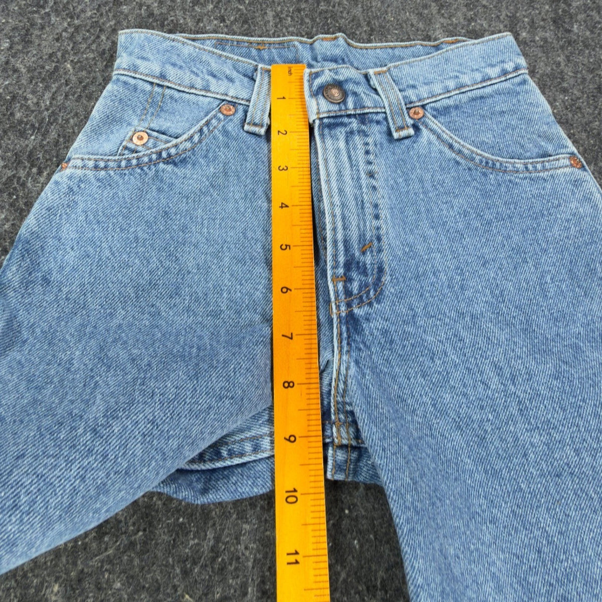 Blue Levi's 550 denim shorts, ruler along front rise