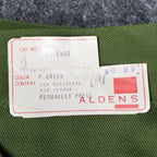 Close-up of the Aldens product label attached to green pants