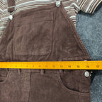 Ruler across the waist of a brown Amy Too corduroy jumper dress