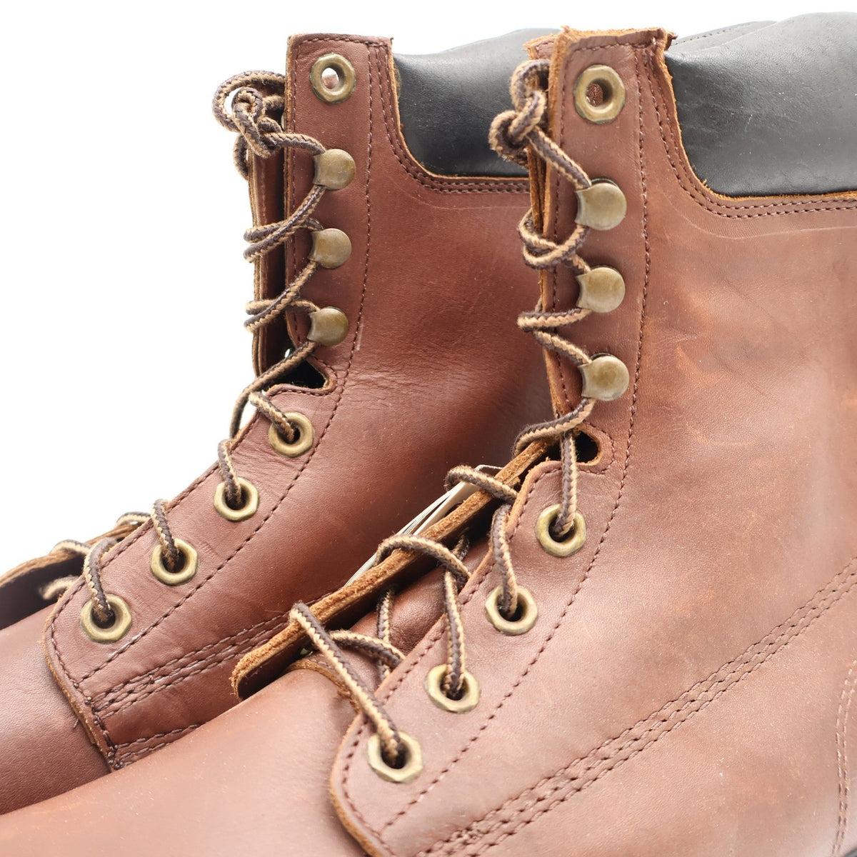 Brown Carolina work boots with black padded collars, close-up of laces, hooks and padded collars
