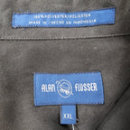 Close-up of the Alan Flusser brand, size and fabric-content labels inside a brown shirt jacket