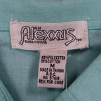 Close-up of the Alexxus brand, size and fabric-content labels inside an aqua blue shirt