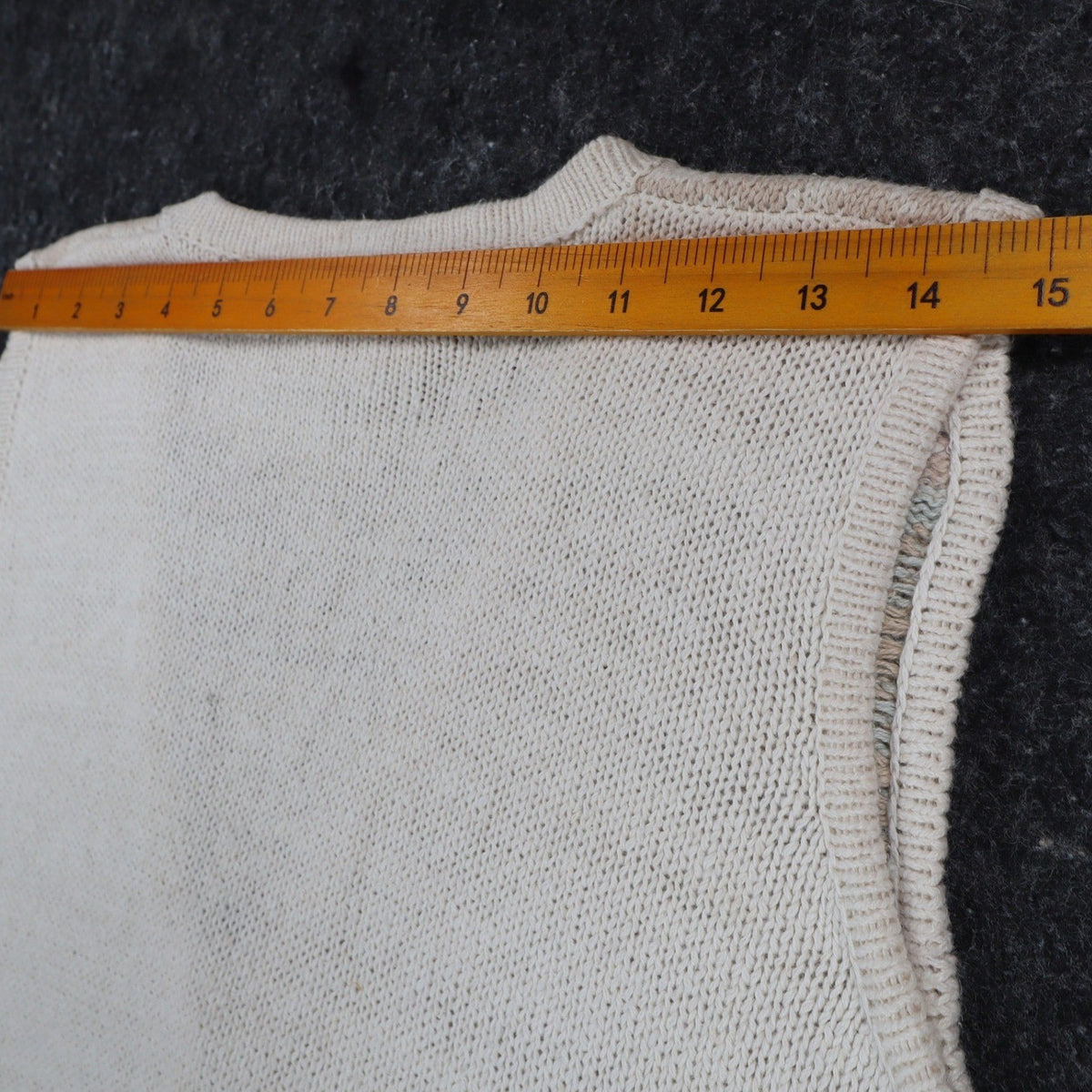 Back of the vest with a ruler across the shoulders