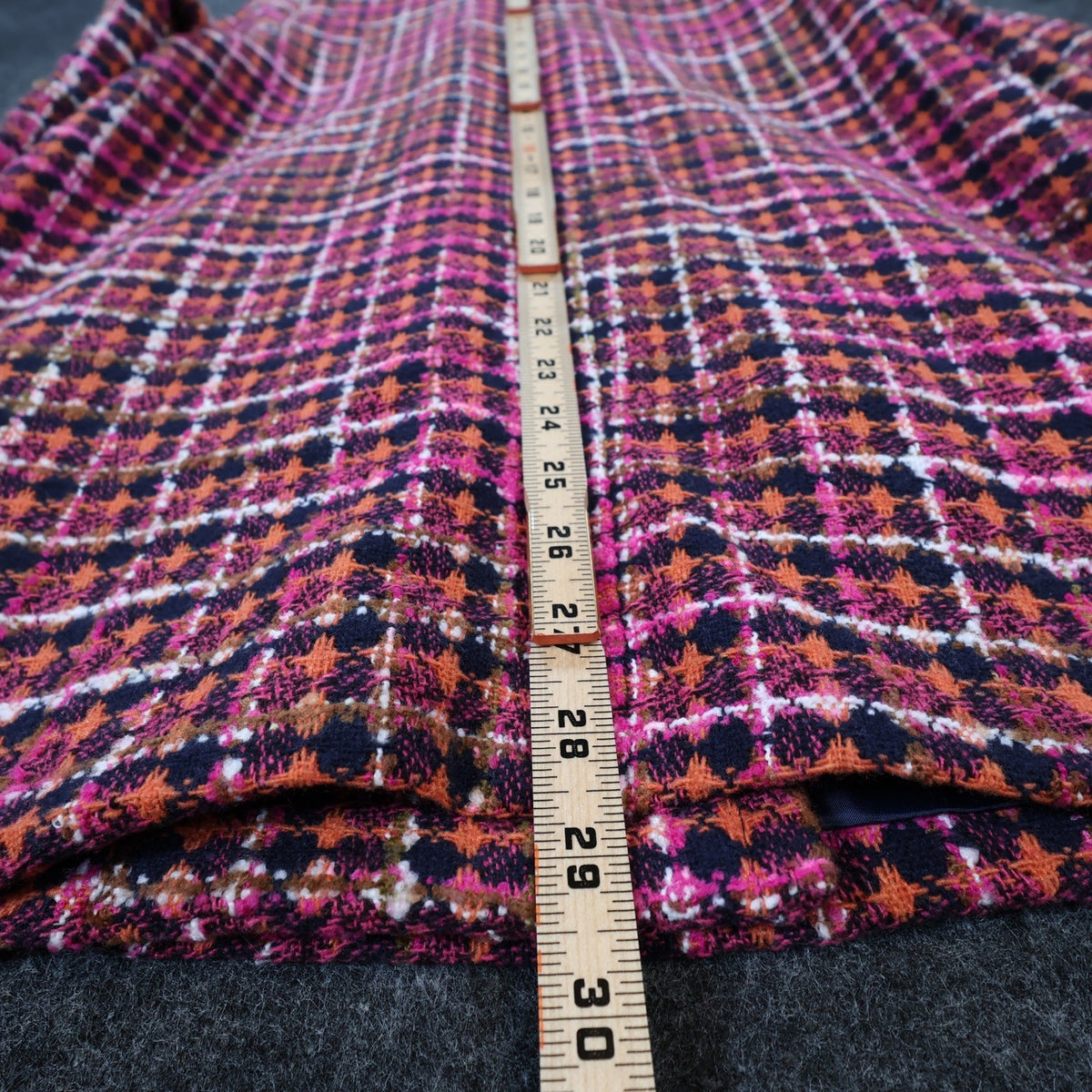 Pink, orange and navy AURA plaid double-breasted coat, measuring tape along the back length