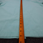 Ruler along the back length of aqua blue Alexxus short-sleeve shirt
