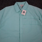 Close-up of the collar and pleated chest panel of an aqua blue Alexxus short-sleeve shirt