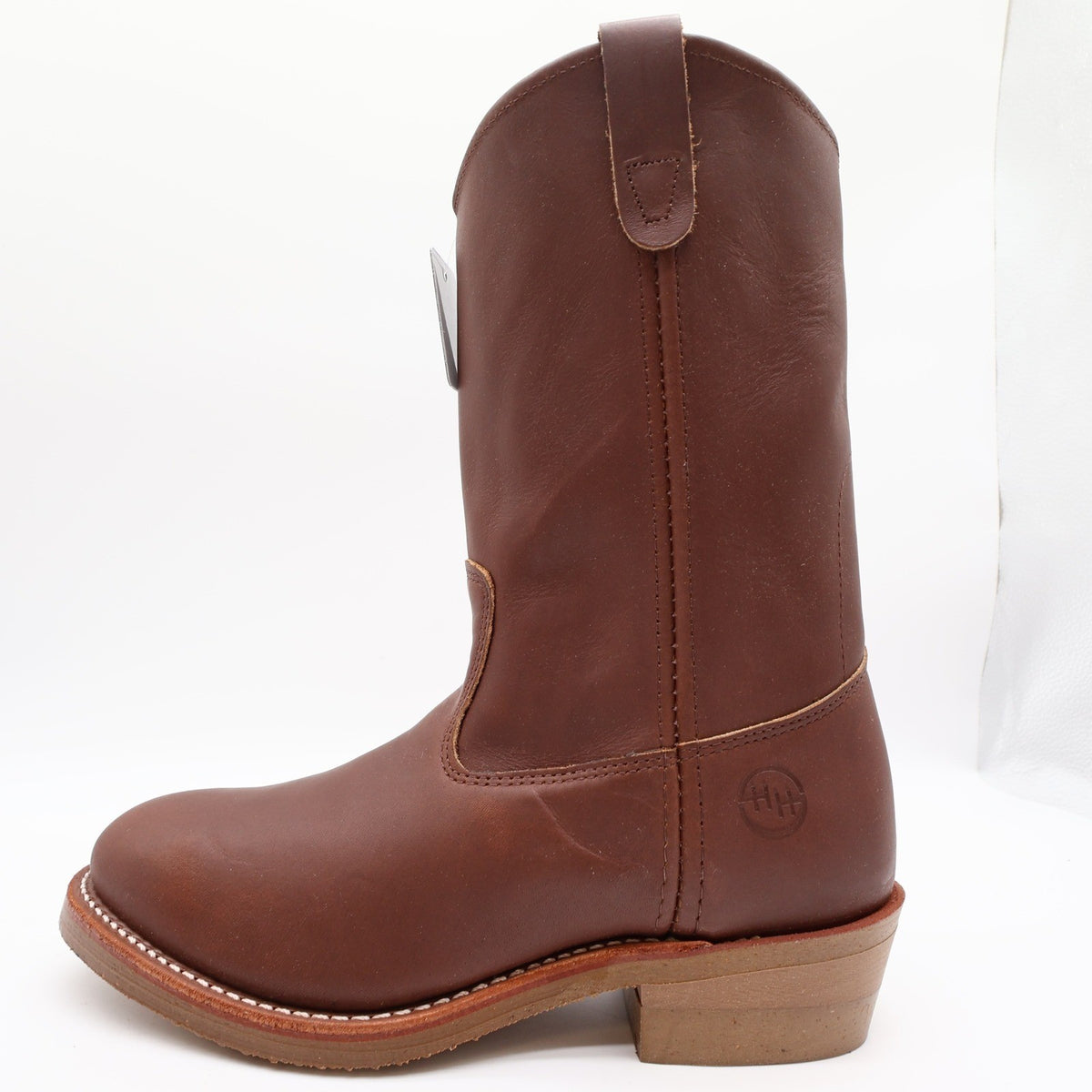 Outer-side view of a brown Double-H pull-on boot, showing the ankle logo and toe pointing left