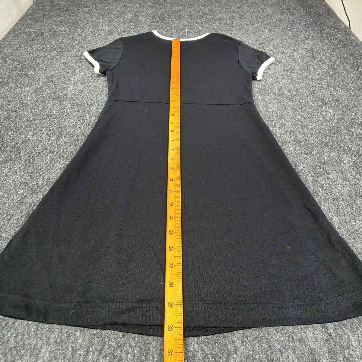 Ruler down the back of a black Angel Jones dress to show its length