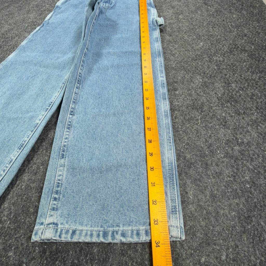 Ruler alongside the outer leg of light blue Lee wide-leg carpenter jeans