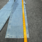 Ruler alongside the outer leg of light blue Lee wide-leg carpenter jeans
