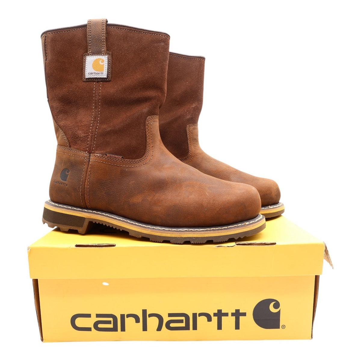 Brown Carhartt pull-on work boots, pair on yellow Carhartt box