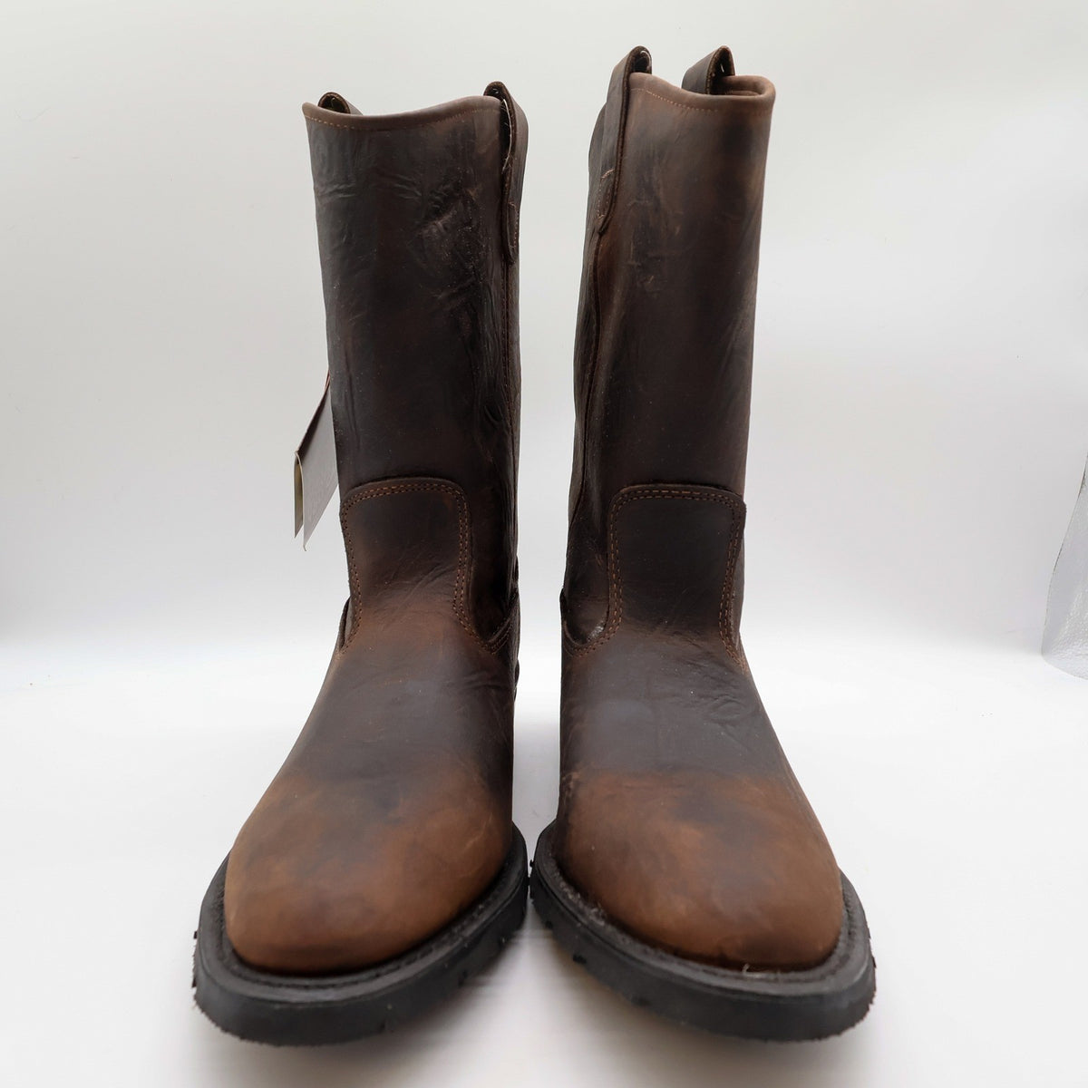 Front view of the pair of dark brown Double-H pull-on boots with black soles