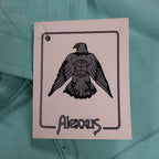 Close-up of the eagle logo on an Alexxus hangtag