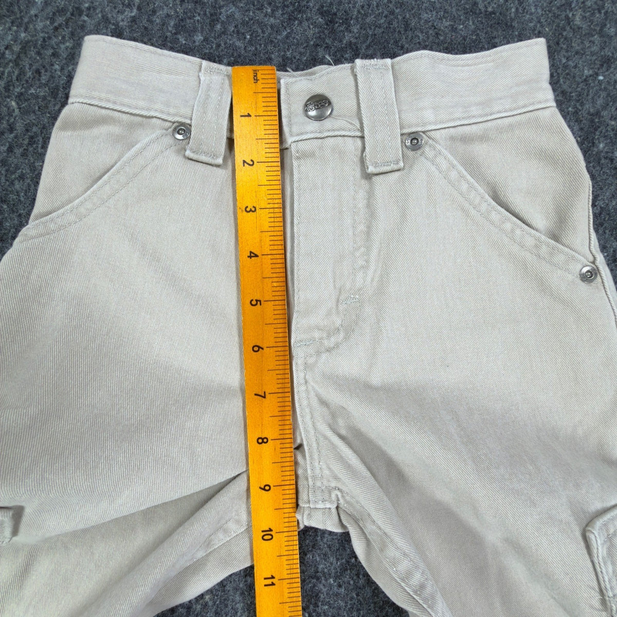 Ruler from the waistband to the crotch of khaki Lee Pipes cargo shorts