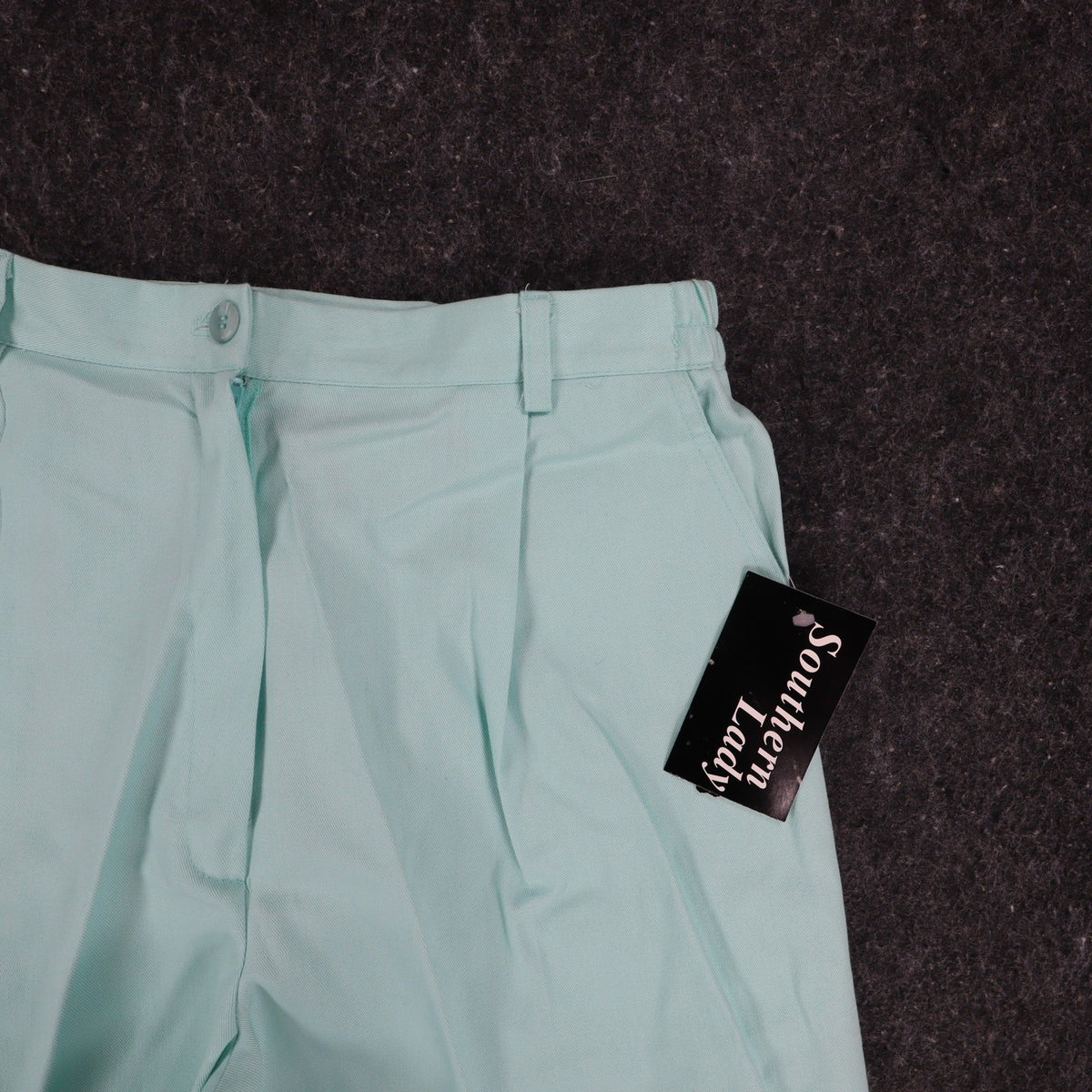Aqua Southern Lady pleated shorts, front pocket and pleat close-up