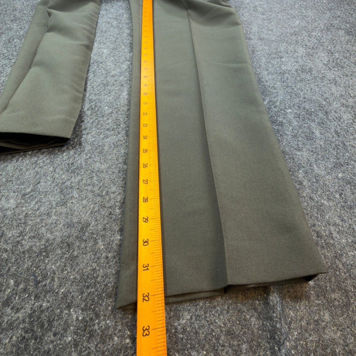 Ruler alongside the inner leg of olive green Glen Oaks pleated trousers