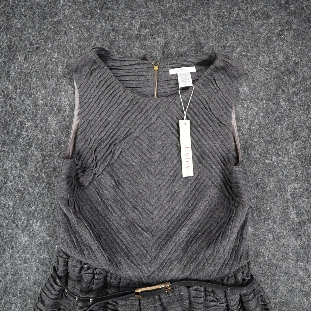 Close-up of the front of charcoal gray Esley sleeveless dress with textured pleats and a black belt