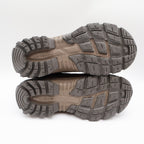 Brown Carhartt lace-up hiking boots with black toe guards, gray and tan lugged outsoles