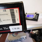 Double-H shoebox with an inventory sticker beside a digital scale