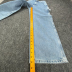 Ruler alongside the inner leg of light blue Lee wide-leg carpenter jeans