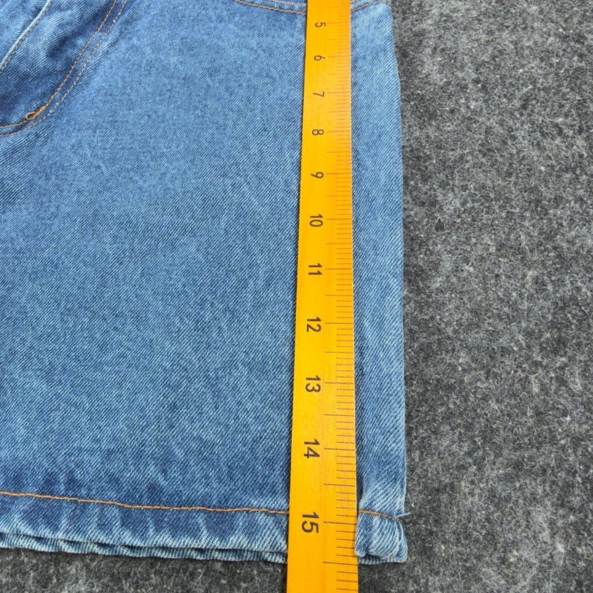 Ruler along the outer leg of blue Boom Boom denim shorts