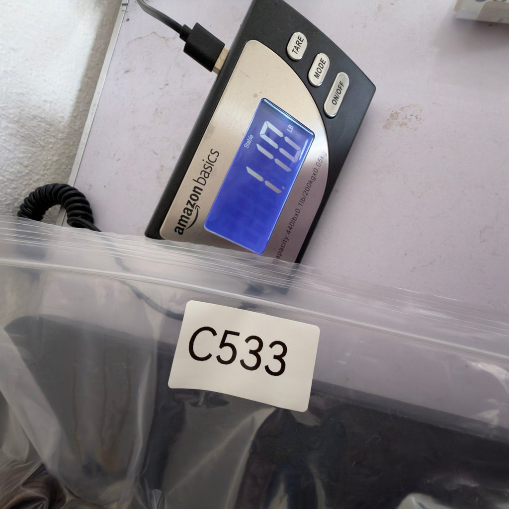 Inventory-labeled clear bag beside a digital scale
